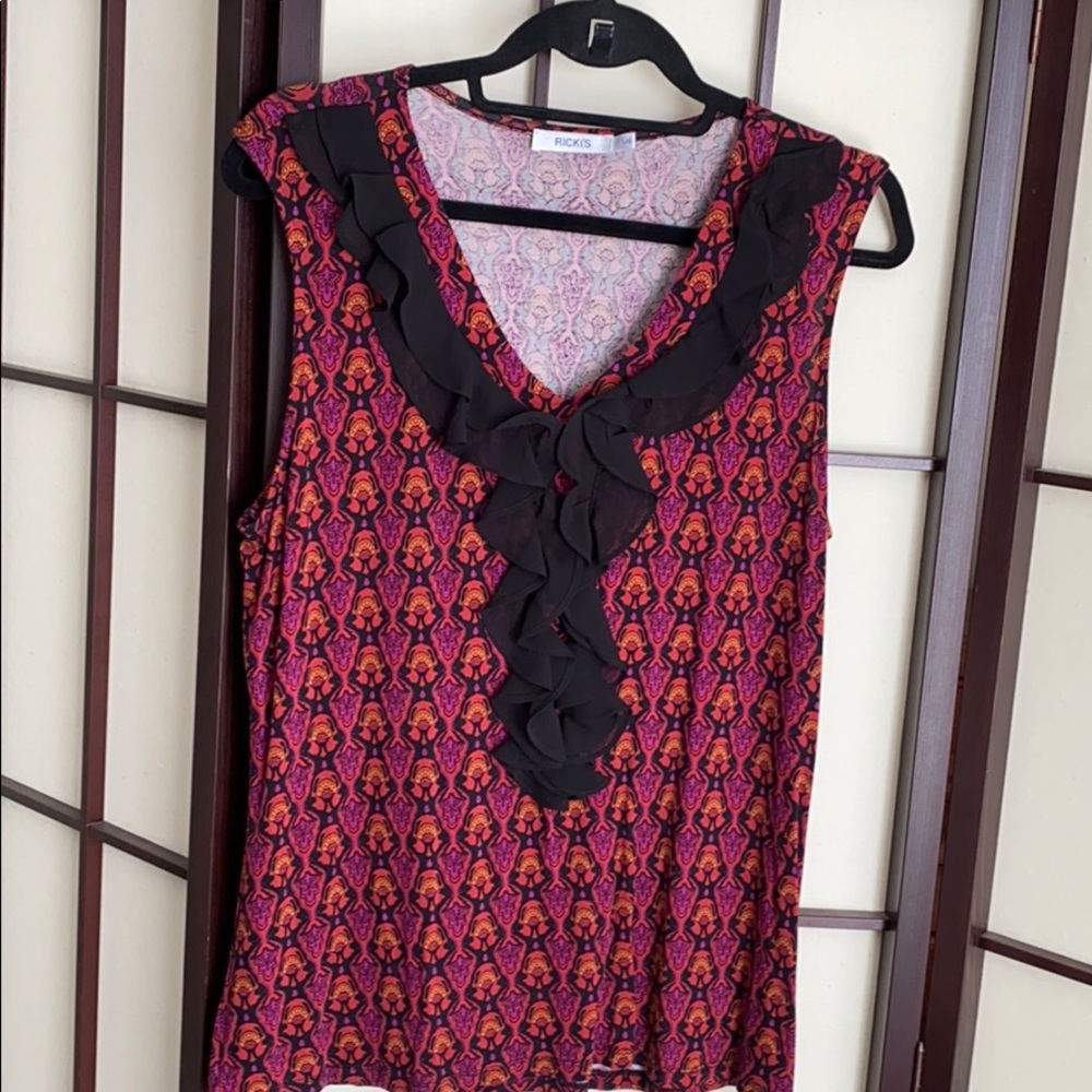 Rickies top with ruffle. Rayon and spandex.